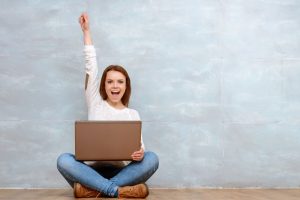 Woman sitting cross-legged pointing up with her arm